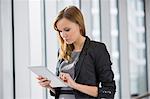 Businesswoman using digital tablet in office