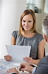 Portrait of beautiful businesswoman with documents in office cafeteria