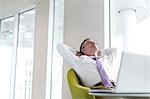 Relaxed mature businessman reclining at lobby