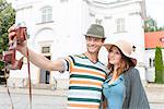 Tourist couple taking self portrait outside St. Casimir Church, Warsaw, Poland