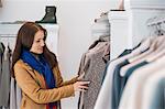 Woman selecting sweater in store