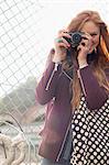 Woman smiling by chain link fence