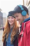 Couple laughing together on city street