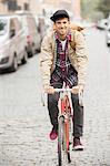 Man riding bicycle on city street