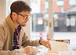 Man drinking coffee in cafe