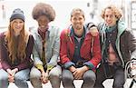 Friends smiling on urban bench