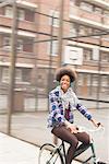 Woman riding bicycle on city street