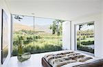 Modern bedroom overlooking rural landscape