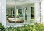 Grass outside window of modern bedroom