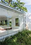 Grass growing outside window of modern bedroom