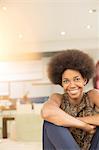 Smiling woman sitting in living room