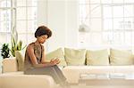 Businesswoman using digital tablet on sofa