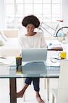 Woman using laptop at desk