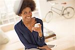 Woman using cell phone in living room