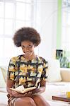 Businesswoman reading book on sofa