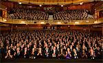 Audience applauding in theater