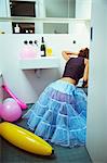 Woman vomiting into toilet at party