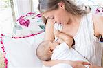 Mother breast-feeding baby boy