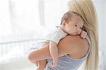 Mother holding baby girl in nursery