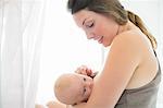 Mother breast-feeding baby girl