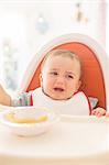 Baby boy crying in high chair