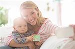 Mother taking self-portrait with baby girl