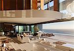 Living room in modern house overlooking ocean