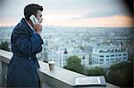 Businessman on cell phone overlooking Paris, France