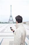 Businessman admiring Eiffel Tower, Paris, France