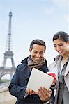 Business people using digital tablet near Eiffel Tower, Paris, France