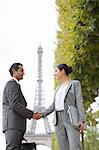 Business people shaking hands near Eiffel Tower, Paris, France