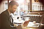 Businessman using laptop in restaurant