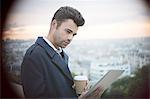 Businessman using digital tablet overlooking Paris, France