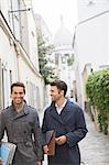 Businessmen walking on street near Sacre Coeur Basilica, Paris, France