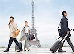 Business people walking near Eiffel Tower, Paris, France