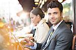 Business people working at sidewalk cafe