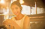 Woman having champagne in restaurant