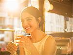 Well-dressed woman drinking champagne in restaurant