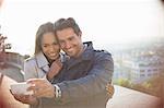 Couple taking self-portrait overlooking city