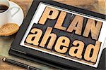 plan ahead phrase in letterpress wood type on a digital tablet with a cup of coffee