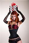 Beautiful redhead pin-up style girl holding gift box, Christmas or holiday theme