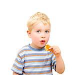 Cute little boy eating delicious cookie isolated on white background