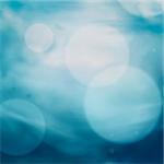 Spring or summer bokeh nature background with blue sea and sky. Ocean blur