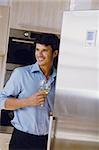 Man with his wineglass in his kitchen at home