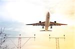 gradient toned passenger jet on landing approach to an airport