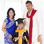 Kindergarten graduation. Asian Indian family, parents and child on kinder graduate day.