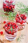 Homemade cranberry lemonade with fresh rosemary. Selective focus.