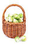 Fresh Raw Brussels Sprouts in Wicker Basket isolated on White background