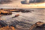 Bay in the Mediterranean Sea with shipwreck at sunset