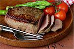 grilled meat beef steak with vegetable garnish (asparagus and tomatoes)